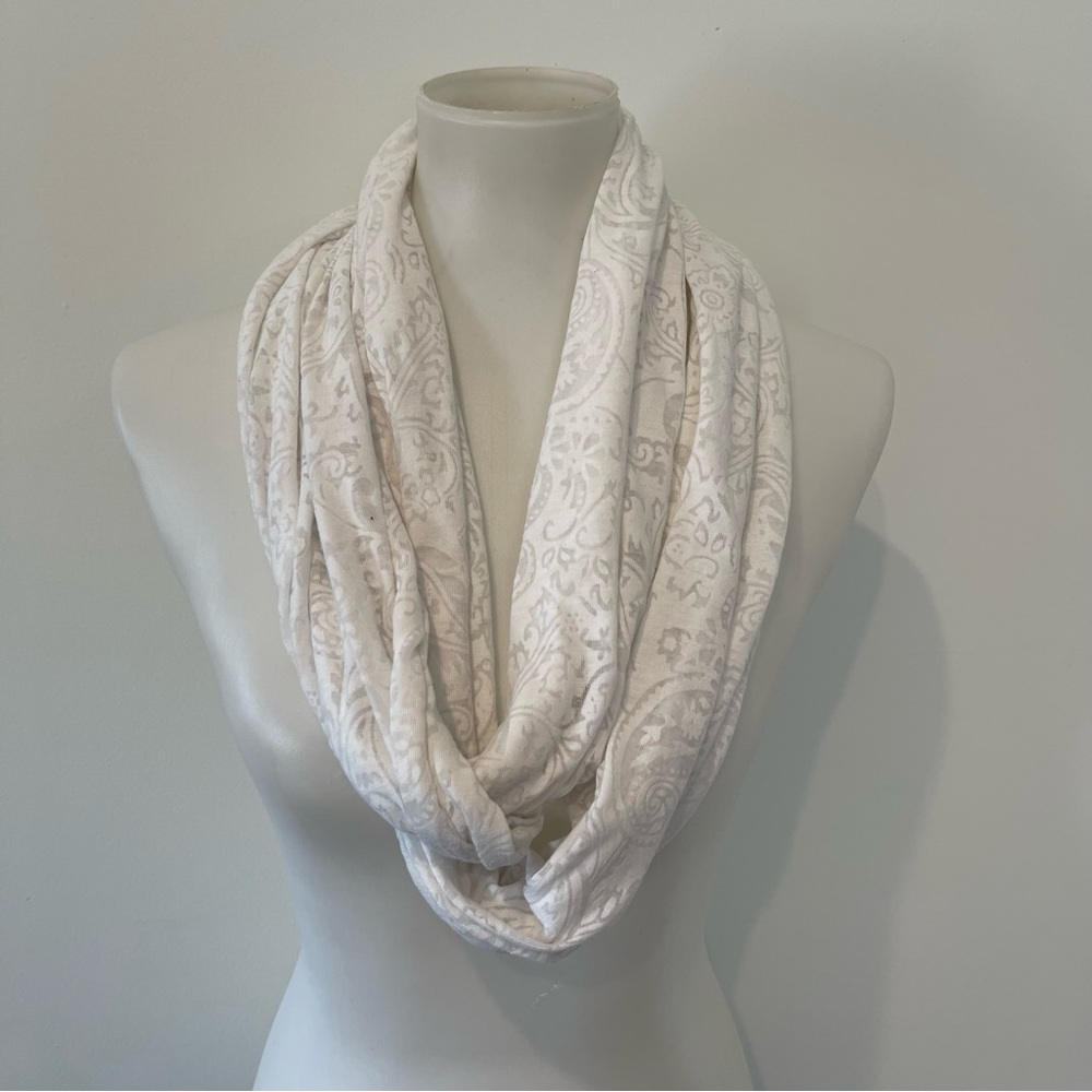 Lightweight white infinity scarf with pattern.